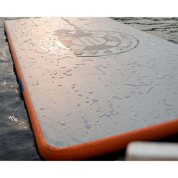 Paradise Pad 6'x10' Inflatable Water Mat on the water with splashes of water on the mat.