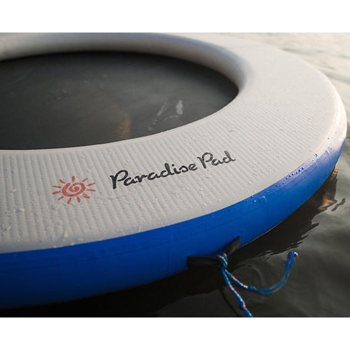 The blue variation of Paradise Pad 8ft Splash Island Water Mat closeup shot on the imprinted logo and brand name in black fonts.