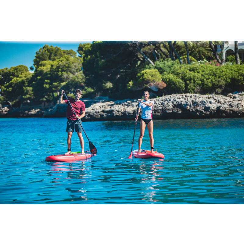 Yarra 10.6 Inflatable Paddle Board in action on the water with 2 adults each stand-up paddling on their respective boards.