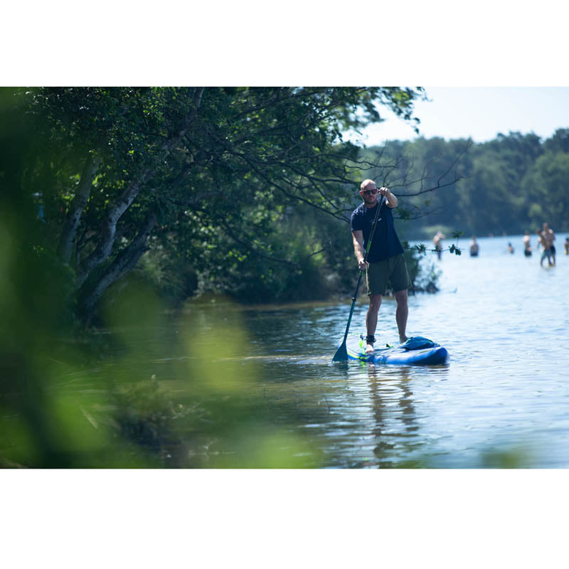 Neva 12.6 Inflatable Paddle Board in action on the water with an adult on it stand-up paddling.