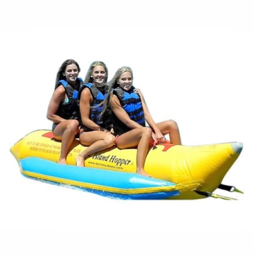 3 girls riding a yellow Island Hopper 3 Person Banana Boat Tube with light blue inflatable foot rests. On a white background. 