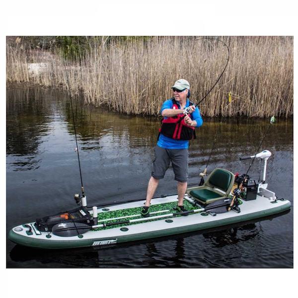 Green/White water camouflage Sea Eagle FishSUP 126 Inflatable SUP top display view with the bag and pump sitting next to the green and white Sea Eagle inflatable Fishing SUP. 