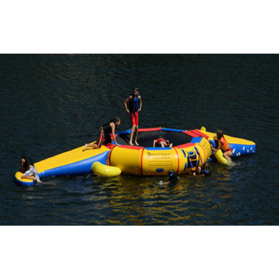 Kids playing on the Island Hopper Gator Monster Head Slide Water Trampoline Attachment attached to a water trampoline out on the lake. 