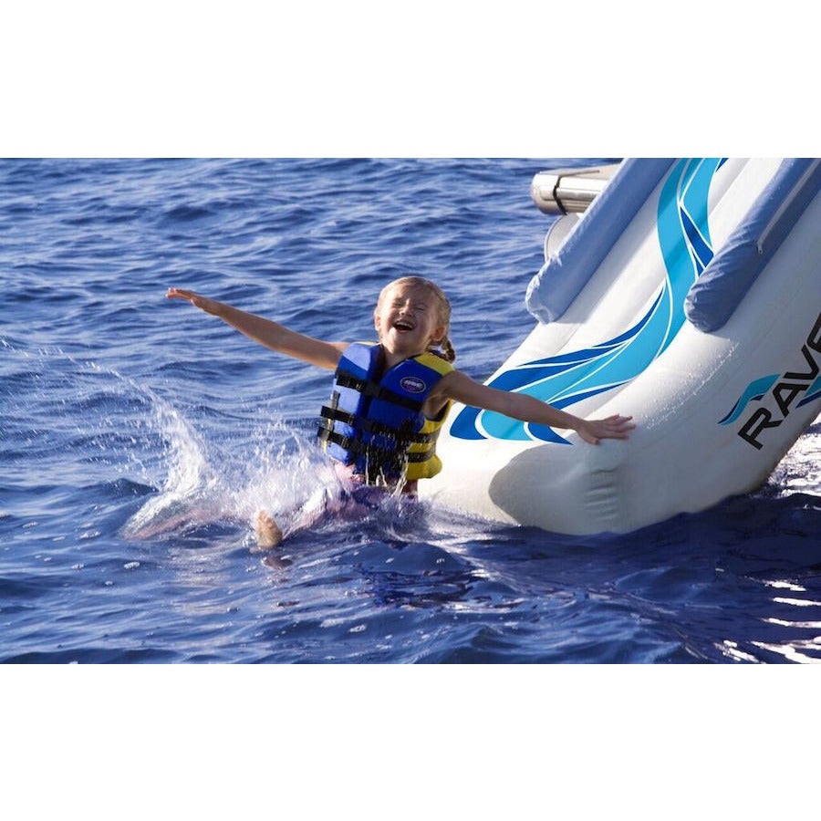 Young girls splashing into the water as she slides off the Rave Infltable Pontoon Water Slide into the lake. 