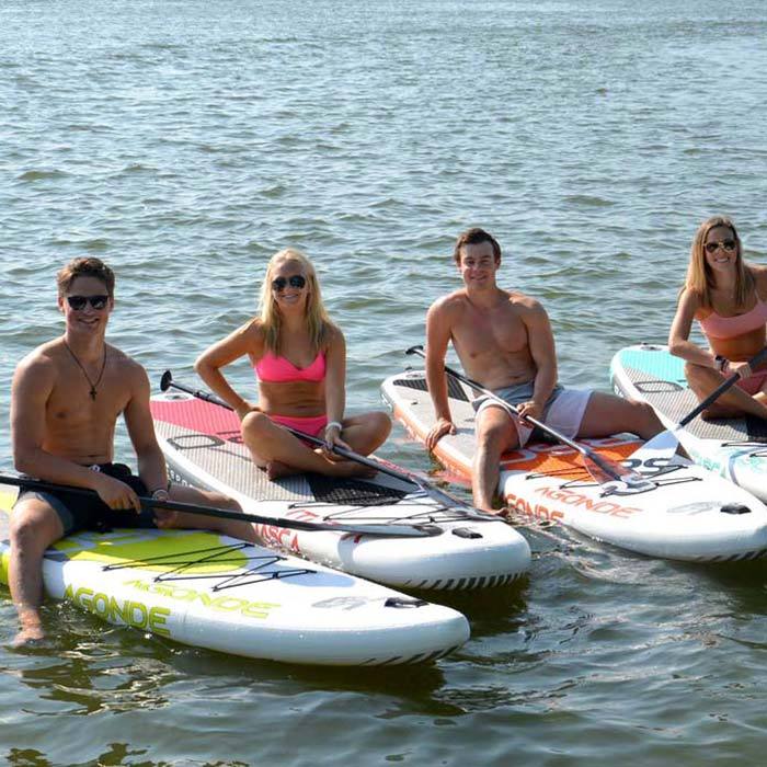 Rave Agonde Inflatable Paddle Board. Image shows white, black, orange and grey color scheme on the top of the board. Beside the top part image of the paddleboard shows the white bottom image with brand trademark. Backpack is the third image.