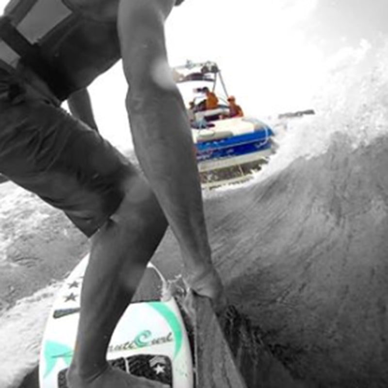 NautiCurl Wake Surfing Wake Shaper in action with a person surfing behind.