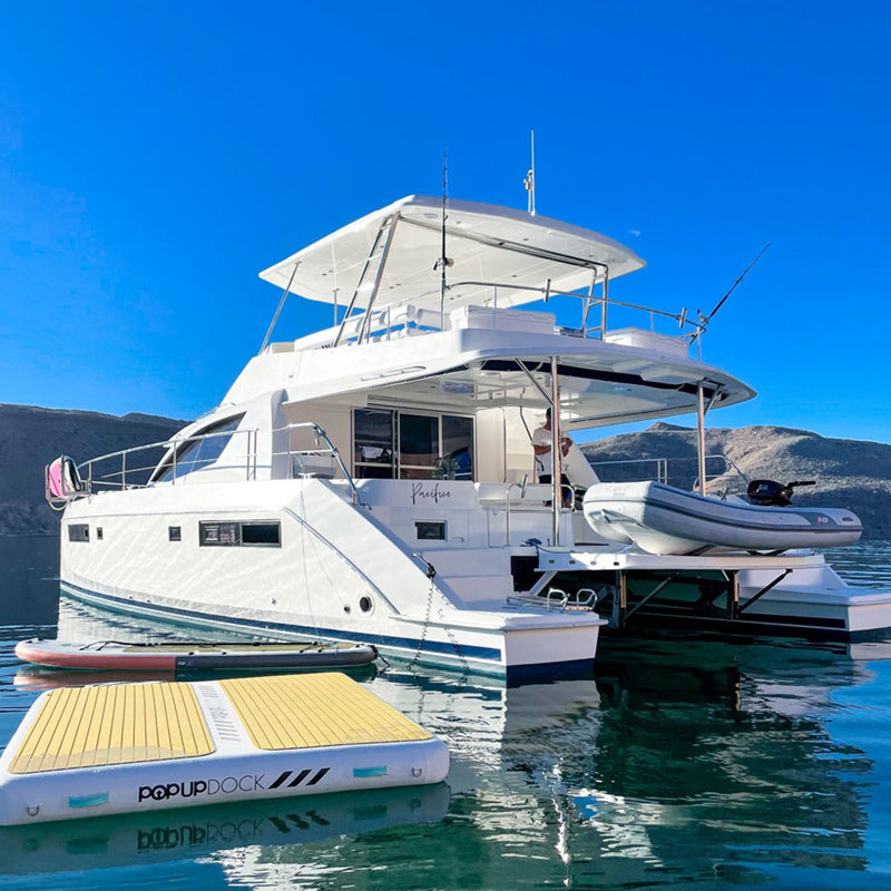 POPUP Inflatable Dock on the water attached to and beside the boat.